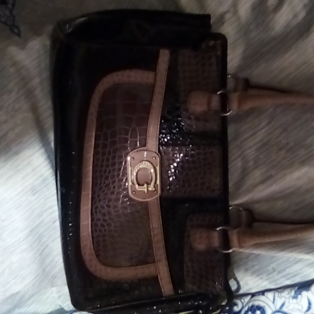 A black and tan leopard print g Guess shoulder purse
